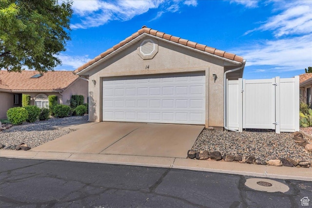1360 E Telegraph Unit 14, Washington, UT 84780 - view of front facade featuring stucco siding, a gate, concrete driveway, and a garage