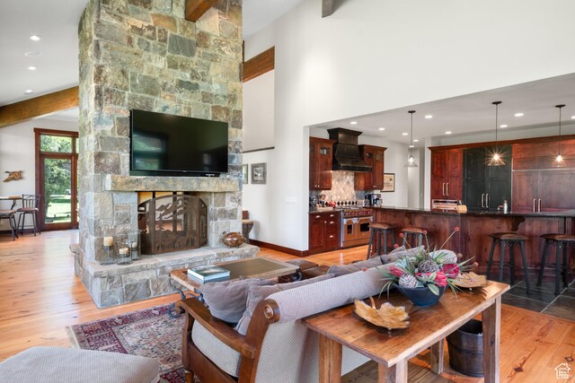 4445 N Millrace Rd, Oakley, UT 84055 - living room with light wood-style floors, a fireplace, recessed lighting, and beamed ceiling