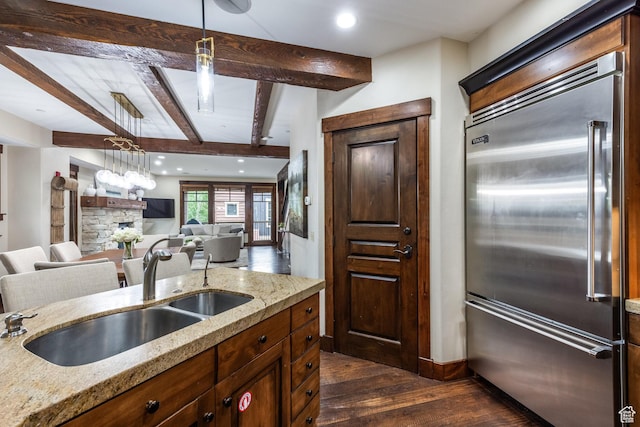 1825 Three Kings Dr Unit 703, Park City, UT 84060 - kitchen featuring built in refrigerator, dark wood finished floors, beamed ceiling, light stone countertops, and open floor plan