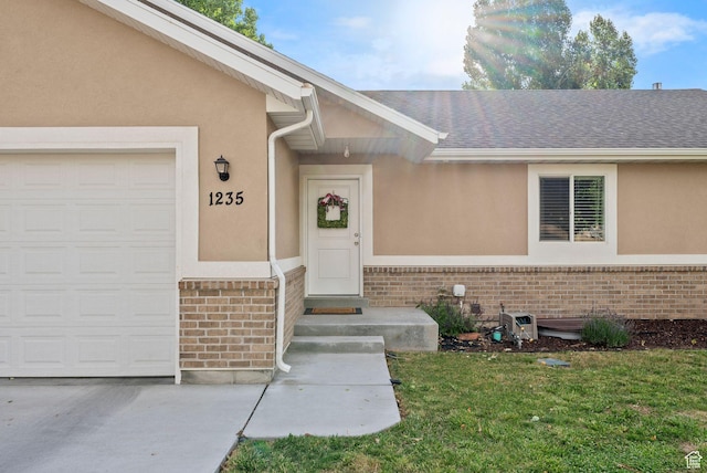 1235 N Valley Hills Blvd, Heber City, UT 84032 - doorway to property with brick siding, stucco siding, a yard, a garage, and roof with shingles
