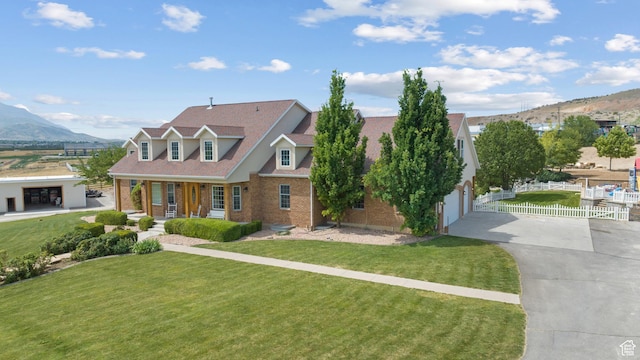 11508 S 5825 W, Payson, UT 84651 - view of front facade featuring concrete driveway, brick siding, a mountain view, and a porch