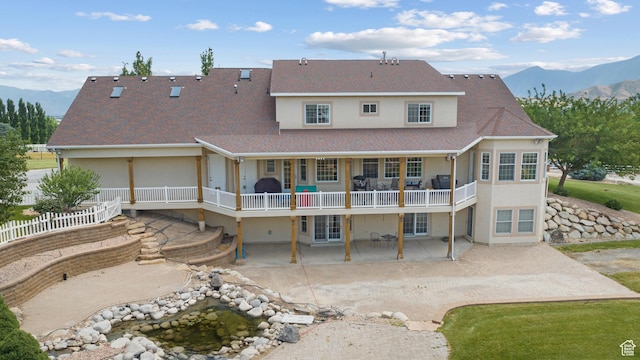 11508 S 5825 W, Payson, UT 84651 - back of property featuring a patio area, stucco siding, a shingled roof, and a deck with mountain view