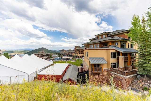 3720 N Sundial Ct Unit B322, Park City, UT 84098 - view of home's exterior featuring a metal roof, a standing seam roof, stucco siding, stone siding, and a mountain view