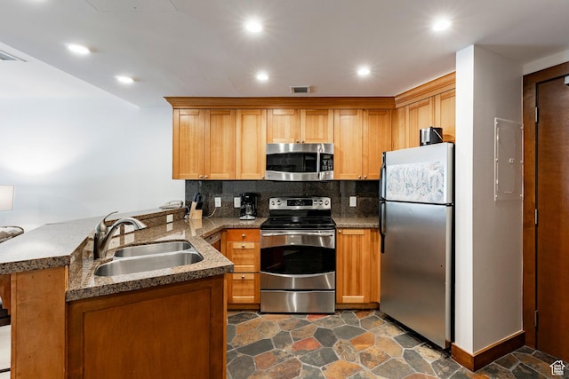 3720 N Sundial Ct Unit B322, Park City, UT 84098 - kitchen featuring appliances with stainless steel finishes, a peninsula, tasteful backsplash, stone countertops, and recessed lighting
