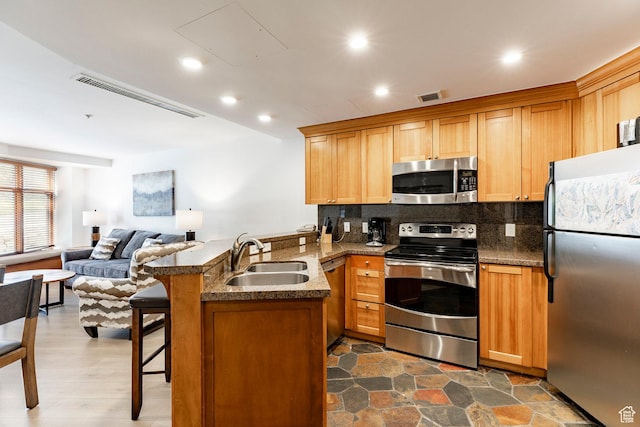 3720 N Sundial Ct Unit B322, Park City, UT 84098 - kitchen with stainless steel appliances, a peninsula, tasteful backsplash, open floor plan, and a breakfast bar