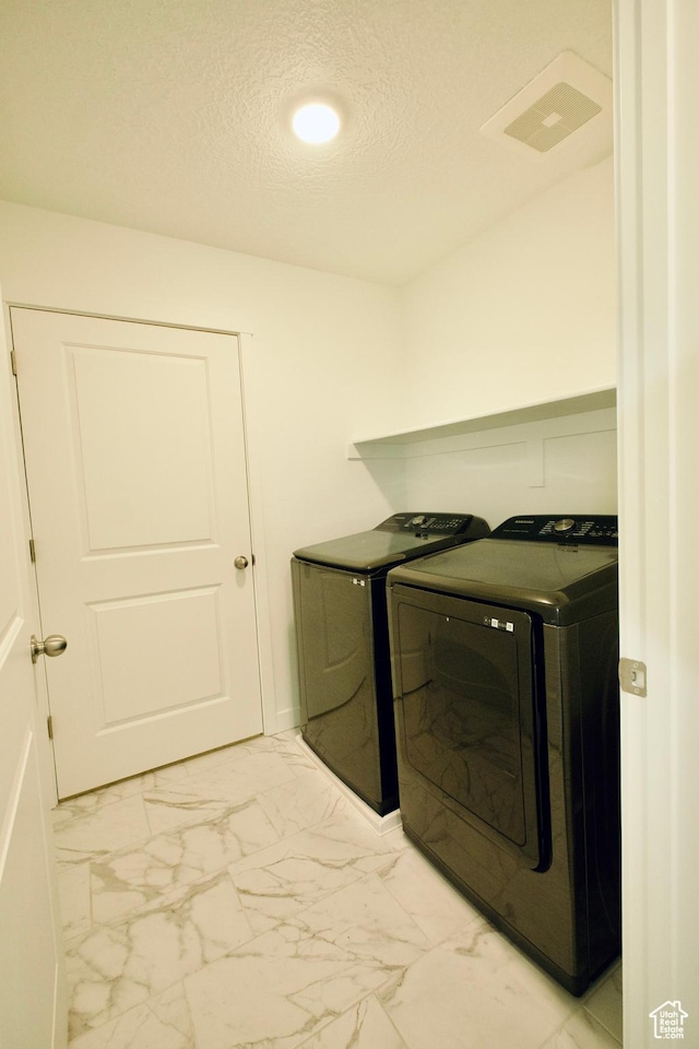 6669 W Skip Rock Rd, South Jordan, UT 84009 - laundry area with washing machine and dryer, light marble finish floors, a textured ceiling, and recessed lighting
