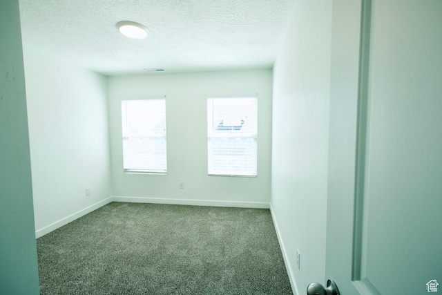 6669 W Skip Rock Rd, South Jordan, UT 84009 - empty room featuring a textured ceiling and dark carpet