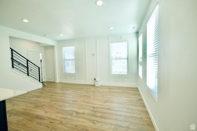 6669 W Skip Rock Rd, South Jordan, UT 84009 - foyer entrance with stairway, light wood-style flooring, a textured ceiling, and recessed lighting