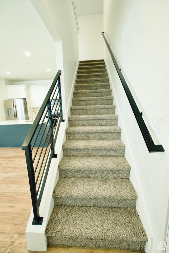 6669 W Skip Rock Rd, South Jordan, UT 84009 - staircase with recessed lighting and wood finished floors