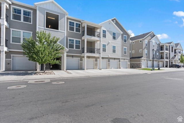 1806 W Newcastle Ln Unit 203, Saratoga Springs, UT 84045 - view of property featuring a residential view, an attached garage, and driveway