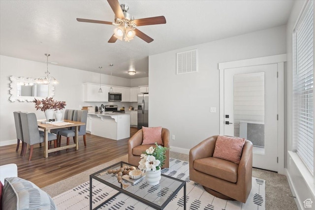 1806 W Newcastle Ln Unit 203, Saratoga Springs, UT 84045 - living area featuring a ceiling fan, light wood-type flooring, and a chandelier