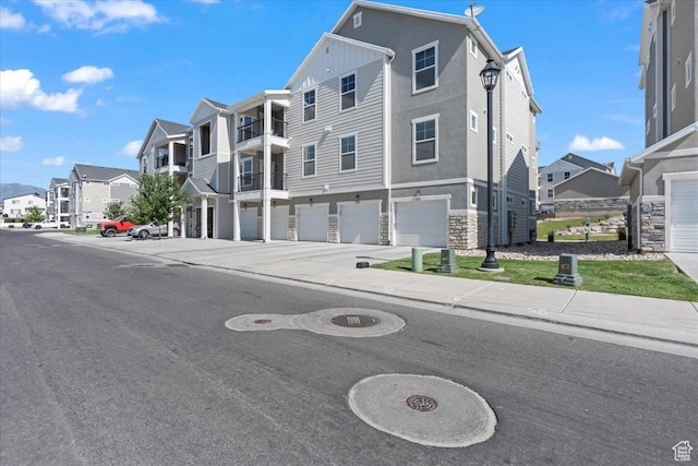 1806 W Newcastle Ln Unit 203, Saratoga Springs, UT 84045 - view of asphalt street with a residential view, sidewalks, curbs, and street lights