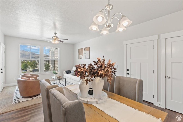 1806 W Newcastle Ln Unit 203, Saratoga Springs, UT 84045 - dining area with wood finished floors, a ceiling fan, a chandelier, and a textured ceiling
