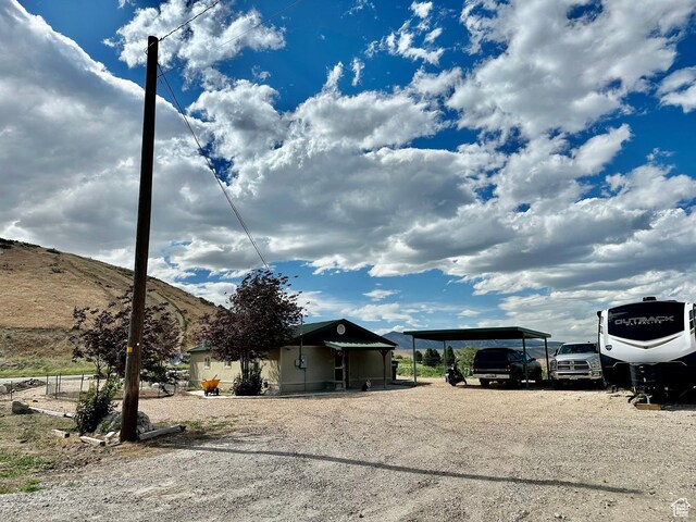 280 W Center St, Sterling, UT 84665 - view of front of property featuring driveway, a carport, and a mountain view