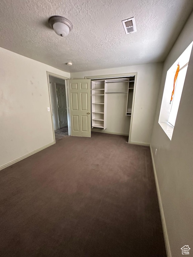 280 W Center St, Sterling, UT 84665 - unfurnished bedroom with a textured ceiling, carpet, and a closet
