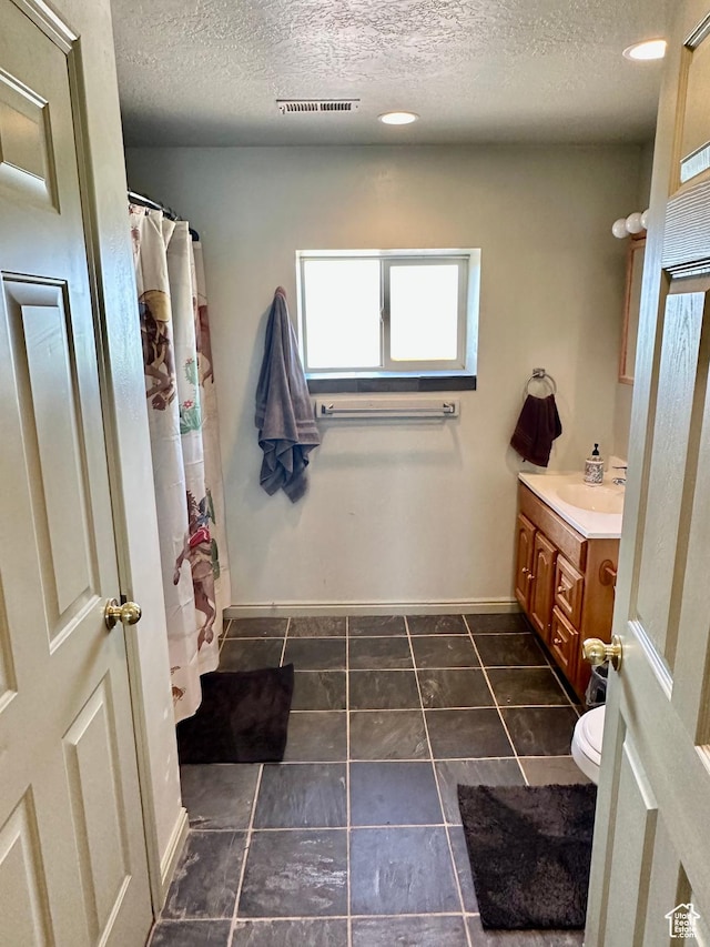 280 W Center St, Sterling, UT 84665 - bathroom with a textured ceiling, vanity, and curtained shower
