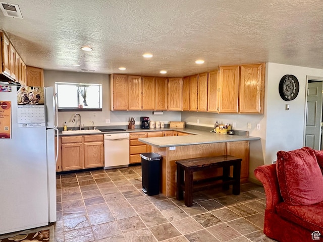 280 W Center St, Sterling, UT 84665 - kitchen with white appliances, a peninsula, a textured ceiling, recessed lighting, and light countertops