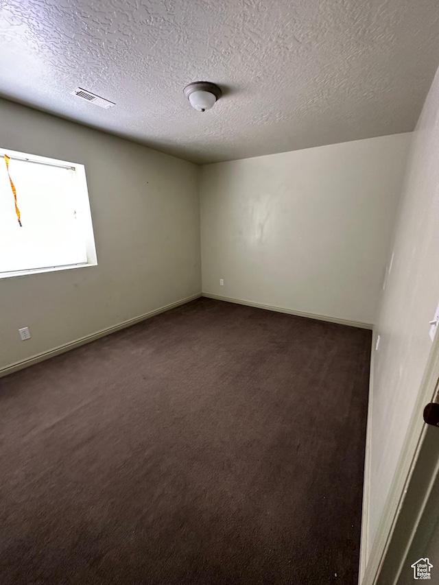 280 W Center St, Sterling, UT 84665 - empty room featuring dark carpet and a textured ceiling