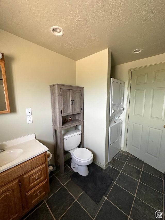 280 W Center St, Sterling, UT 84665 - bathroom with stacked washer / drying machine, vanity, a textured ceiling, tile patterned flooring, and recessed lighting