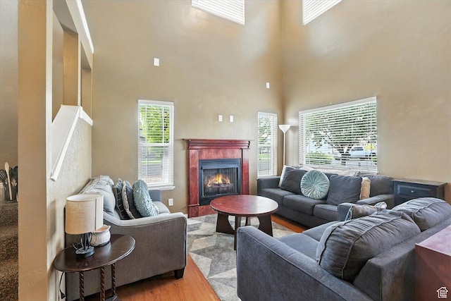487 W 1490 N Unit 106, Logan, UT 84341 - living room with wood finished floors, a high ceiling, and a tile fireplace
