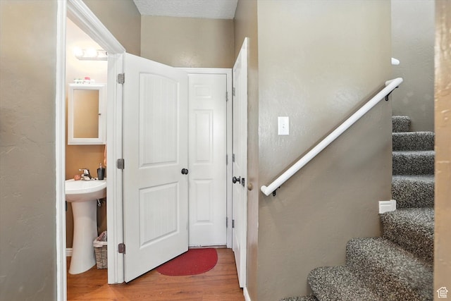487 W 1490 N Unit 106, Logan, UT 84341 - stairway featuring wood finished floors and a textured wall