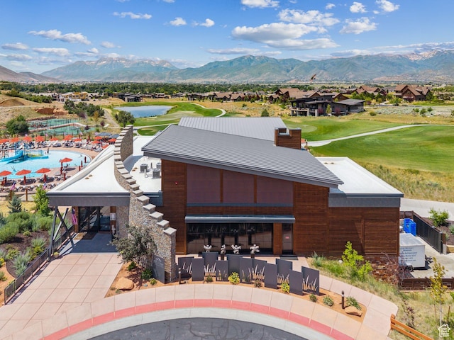 3057 E Corral Peak Cir Unit 147, Heber City, UT 84032 - back of house featuring view of golf course, a water and mountain view, concrete driveway, a residential view, and a chimney