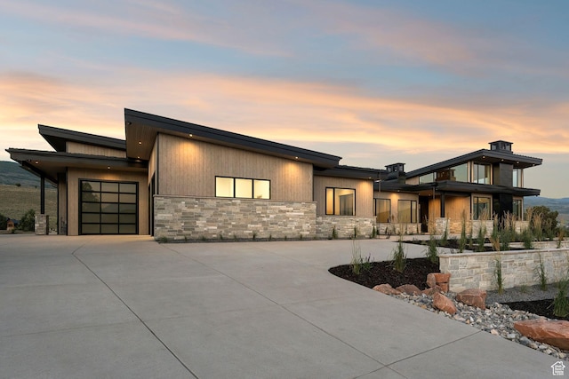3057 E Corral Peak Cir Unit 147, Heber City, UT 84032 - contemporary house featuring stone siding, a garage, and concrete driveway
