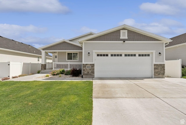 4913 W Olympic View Dr S, Kearns, UT 84118 - craftsman-style home featuring stone siding, a porch, concrete driveway, and an attached garage