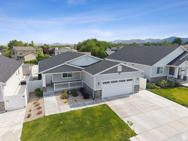 4913 W Olympic View Dr S, Kearns, UT 84118 - craftsman inspired home featuring stone siding, covered porch, a garage, a gate, and a mountain view