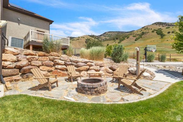 2330 E Meadow Lark Ln, North Logan, UT 84341 - view of patio / terrace featuring an outdoor fire pit and a mountain view