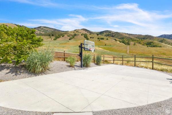 2330 E Meadow Lark Ln, North Logan, UT 84341 - view of patio / terrace featuring basketball hoop, a mountain view, and a view of countryside