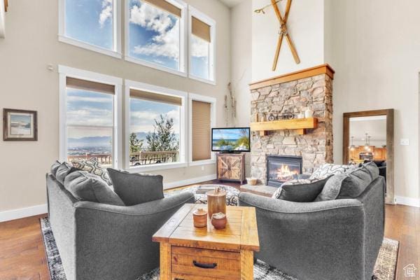 2330 E Meadow Lark Ln, North Logan, UT 84341 - living area featuring a high ceiling, wood finished floors, and a stone fireplace