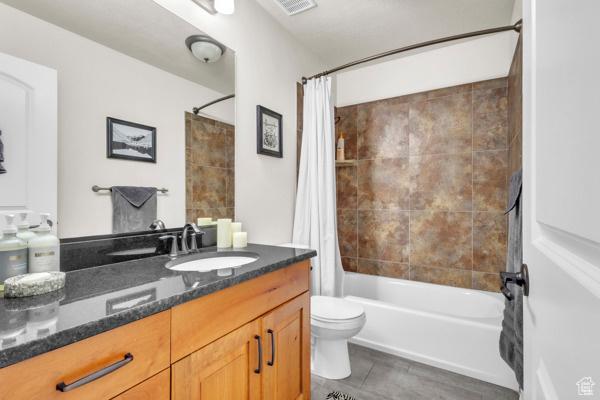 2330 E Meadow Lark Ln, North Logan, UT 84341 - bathroom featuring vanity, shower / tub combo with curtain, and tile patterned flooring