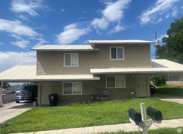 526 W 200 S, Brigham City, UT 84302 - view of front of property featuring a carport, stone siding, a metal roof, a front lawn, and driveway