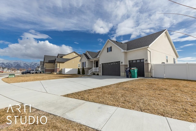 3643 W 650 N, Layton, UT 84041 - view of side of home with stucco siding, a mountain view, driveway, and a garage