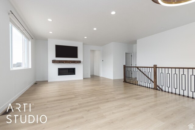 3643 W 650 N, Layton, UT 84041 - unfurnished living room featuring light wood finished floors, a glass covered fireplace, and recessed lighting
