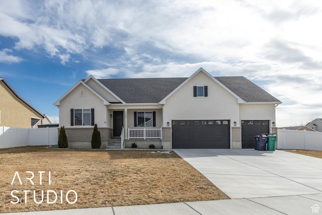 3643 W 650 N, Layton, UT 84041 - view of front of home with covered porch, stucco siding, driveway, and roof with shingles
