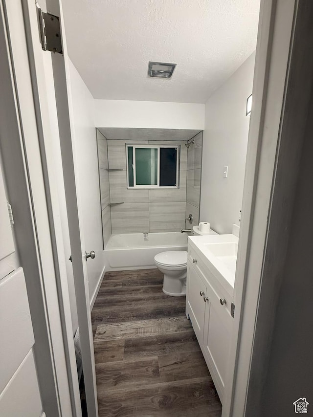 318 E 100 N, Brigham City, UT 84302 - full bath featuring wood finished floors, shower / bathtub combination, vanity, and a textured ceiling