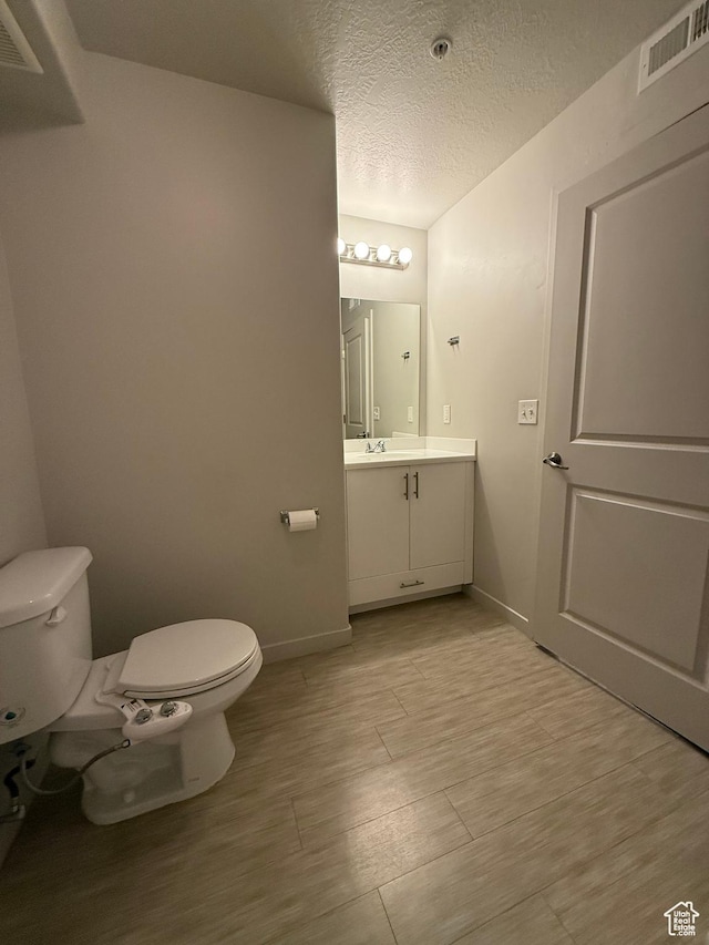 1055 W 1033 N Unit 301, Orem, UT 84057 - bathroom featuring vanity, wood finished floors, and a textured ceiling