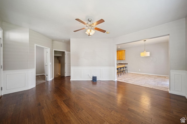 159 S 930 E, American Fork, UT 84003 - unfurnished living room featuring ceiling fan, a wainscoted wall, wood finished floors, and a decorative wall