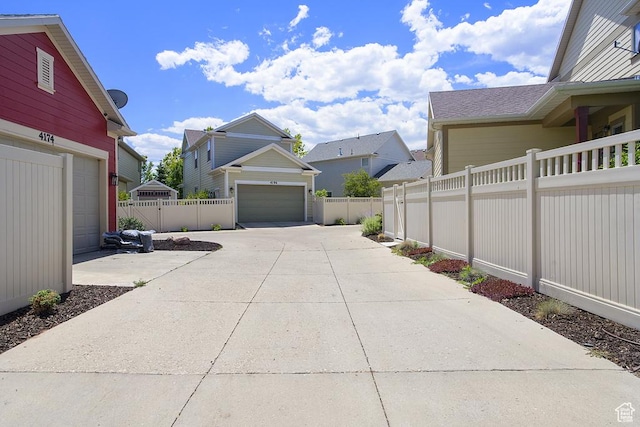 10907 Tahoe Way S, Jordan, UT 84009 - view of yard with a garage, concrete driveway, and a residential view
