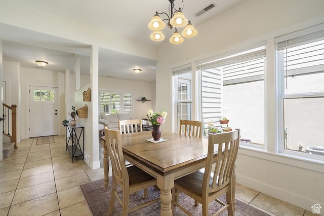 10907 Tahoe Way S, Jordan, UT 84009 - dining area featuring light tile patterned flooring, a chandelier, and stairway