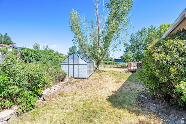 1888 W 7265 S, West Jordan, UT 84084 - view of green lawn featuring an exterior structure, an outbuilding, and a deck