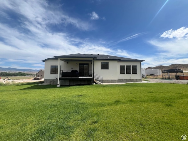 420 W 350 N, Gunnison, UT 84634 - rear view of property featuring a lawn, a mountain view, and stucco siding