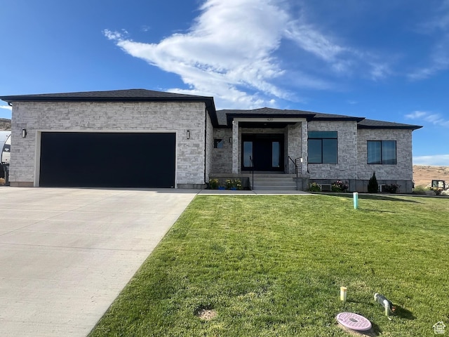 420 W 350 N, Gunnison, UT 84634 - view of front facade featuring a front yard, a garage, driveway, and stone siding