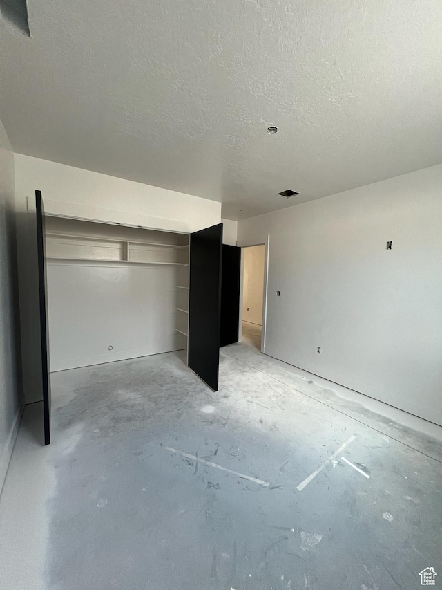 420 W 350 N, Gunnison, UT 84634 - unfurnished bedroom with a textured ceiling and concrete floors