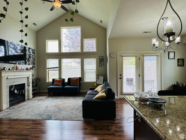 10227 Mystic Brook Way S, South Jordan, UT 84095 - living room with ceiling fan, dark wood finished floors, a fireplace, high vaulted ceiling, and a chandelier