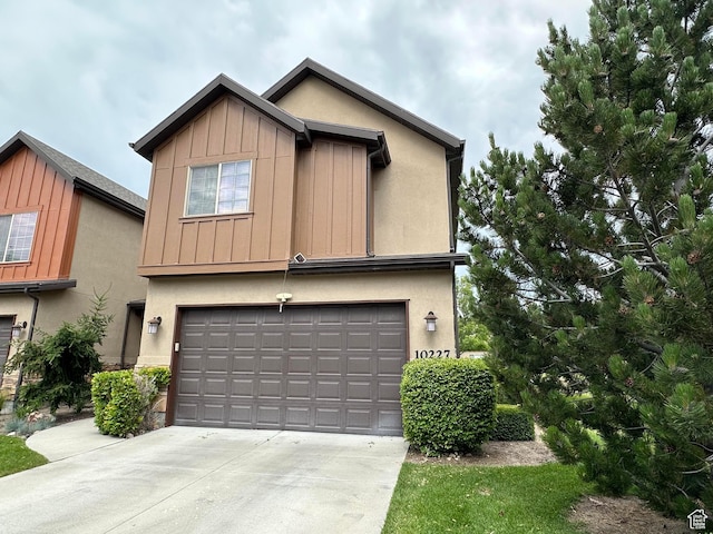 10227 Mystic Brook Way S, South Jordan, UT 84095 - view of front facade featuring a garage, board and batten siding, concrete driveway, and stucco siding