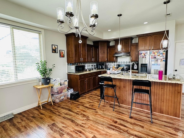 10227 Mystic Brook Way S, South Jordan, UT 84095 - kitchen with appliances with stainless steel finishes, light wood finished floors, plenty of natural light, and tasteful backsplash
