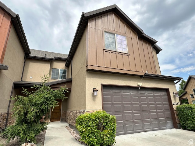 10227 Mystic Brook Way S, South Jordan, UT 84095 - view of front of home featuring stone siding, driveway, a garage, board and batten siding, and stucco siding